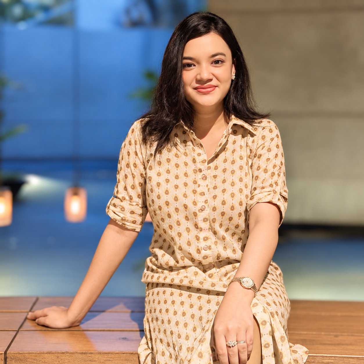 Kheya Sharif in a patterned outfit, seated in warm light